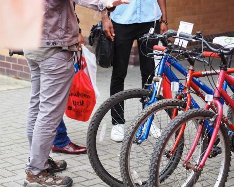 A group of students standing beside a bicycle rack