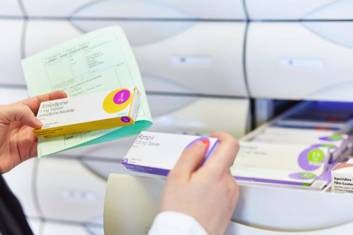 Student handling prescriptions in a Pharmacy setting