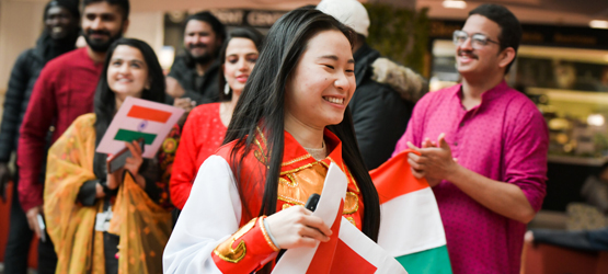 Smiling students celebrating their country at the One World Festival