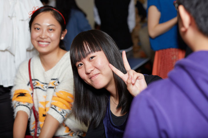 A student giving the peace sign