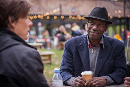 Age positive dementia image - a man and woman sitting for coffee