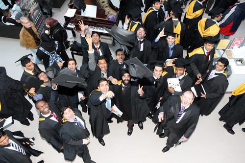 Graduates stood in a group with gowns on