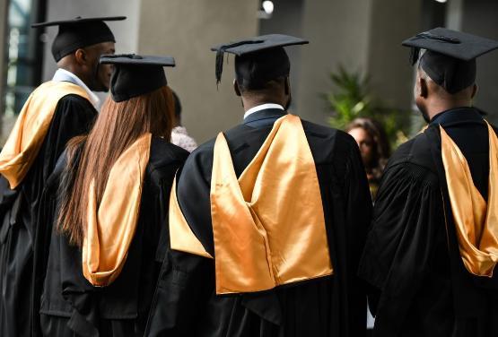 Graduates celebrating in their robes