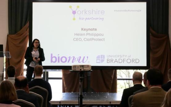 Person stood at a conference podium gives speech during event