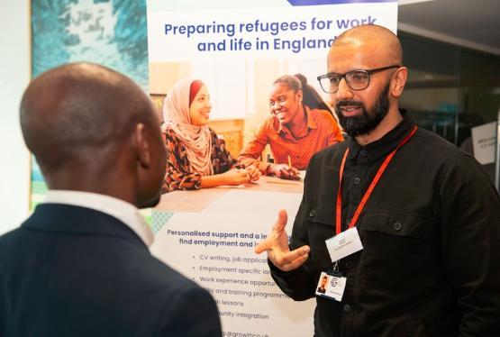 Two people talking at a conference