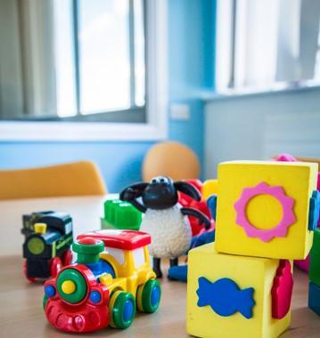 Childrens playing blocks and a plastic toy