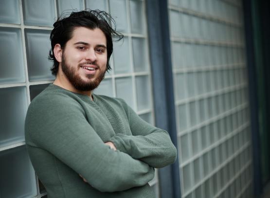 Student leaning on wall