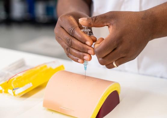 A student nurse simulating an injection