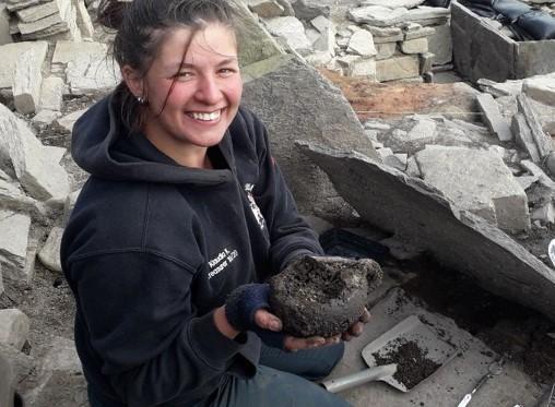 Archaeologist holding Iron Age cup