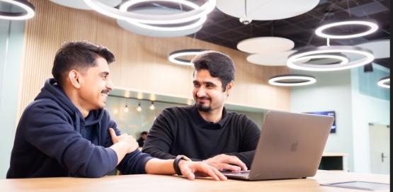 Two students using a laptop in Student Central