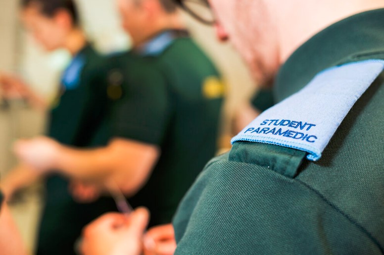 A student paramedic using equipment