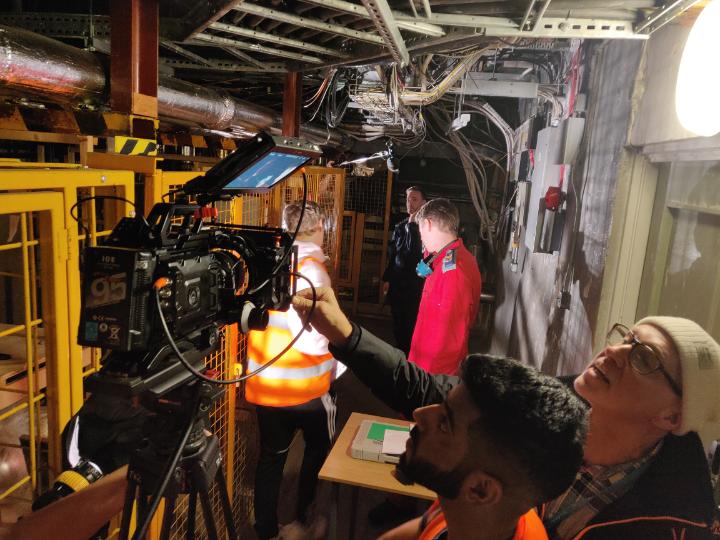 People setting up a camera in the basement of the Richmond Building.