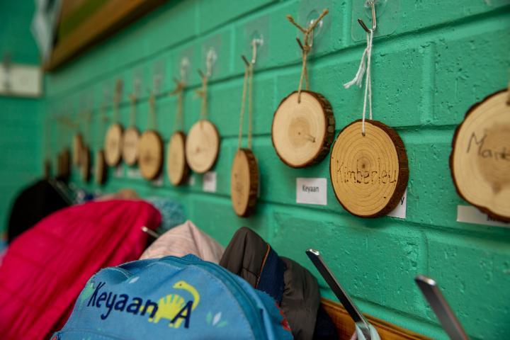 Childrens names on wooden pegs at nursery