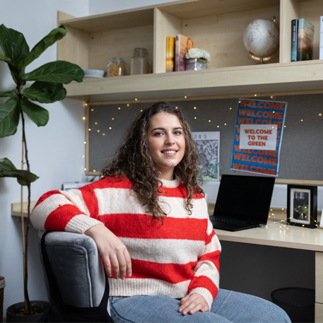 A student sitting at their desk in The Green on-campus accommodation