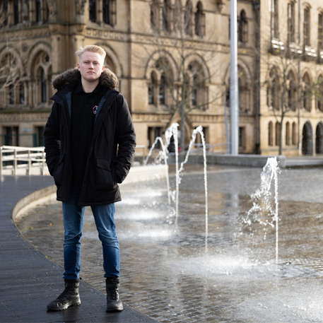 A stood in front or the Mirror Pool in City Park, Bradford