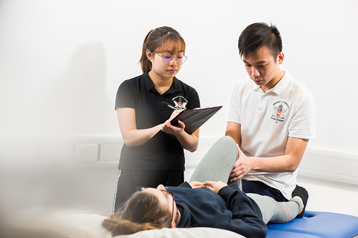 Students doing a physio session with a client