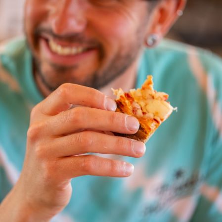 Person eating pizza