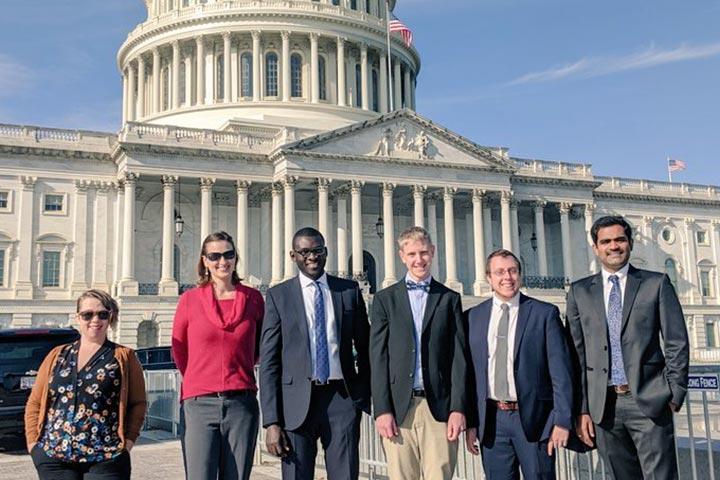 Six people stood in front of the Washington State Capitol Building