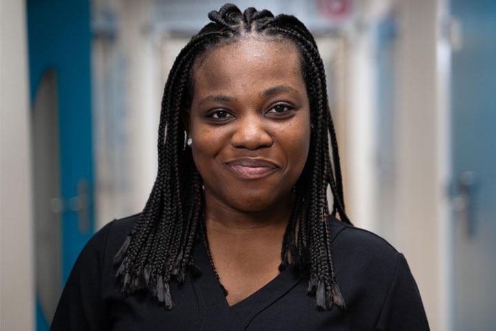 A head and shoulders photo of a person smiling at the camera.