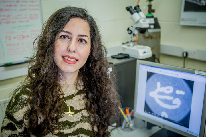 MSc Archaeological Sciences student Maedeh Darzi with a computer monitor showing her project work