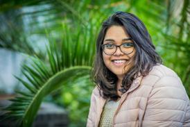 Close up of MSc International Strategic Marketing student Sravani Karnam in front of plants in the Bright Building