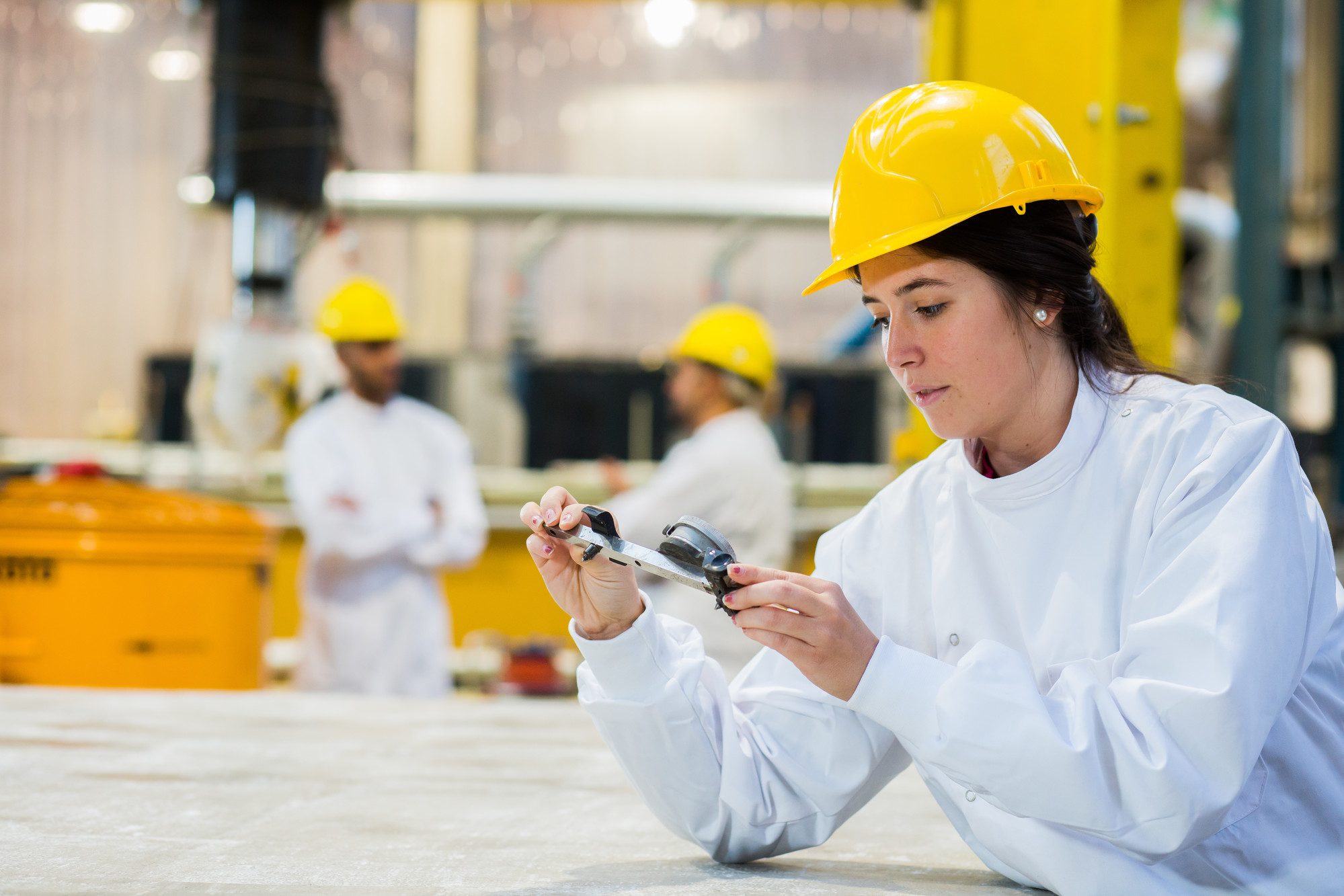 A civil engineering student wearing a yellow hard hat.