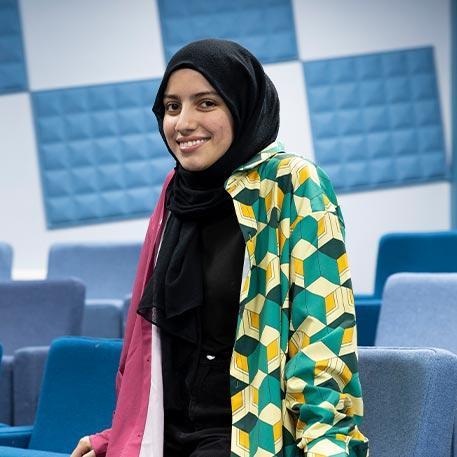 A student smiling at the camera.