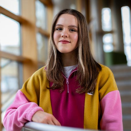 A student smiling at the camera.