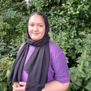 Staff member Aliya standing in the nursery garden