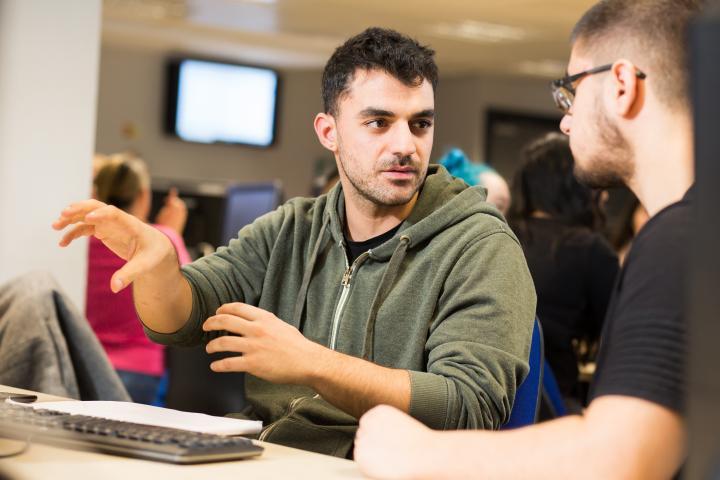 Two male students having a discussion.