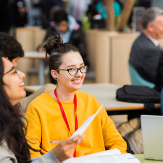 Student smiling in the University of Bradford Richmond building atrium