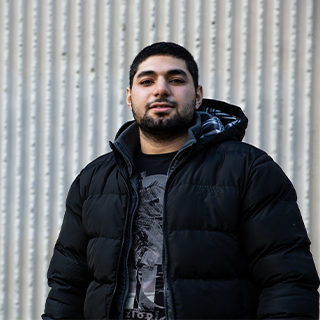 Abdalrahman, a Chemical Engineering student, stood in front of a light background, smiling at the camera.