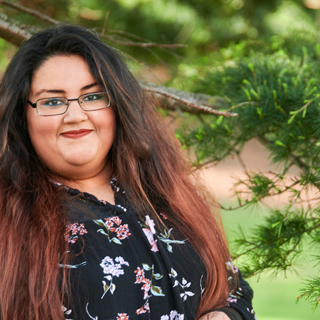 Nabila, a pharmacy student, smiling at the camera.